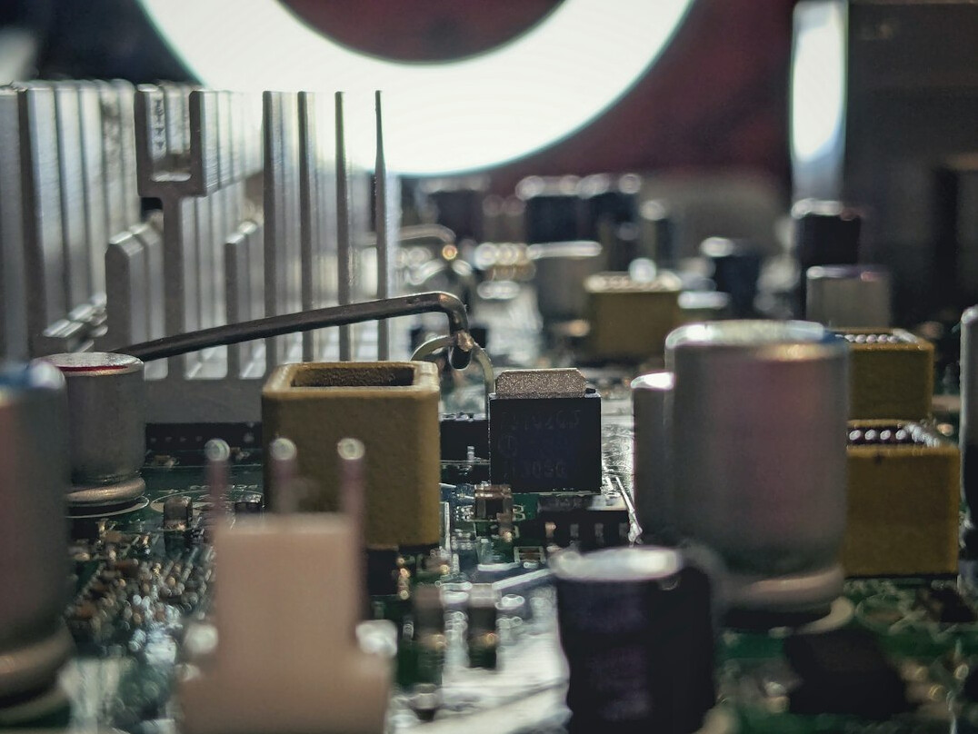 Close up of a green circuit board with electronic components